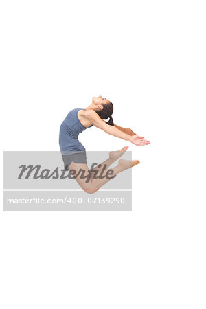 Flexible sporty brunette jumping in the air on white background