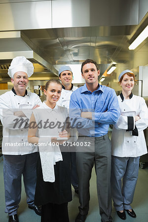 Restaurant team posing together in a kitchen