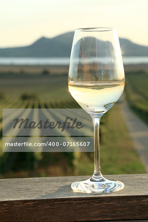 Wine glass at sunset in Southern Moravia. The Palava mountains and Vineyards in the background.