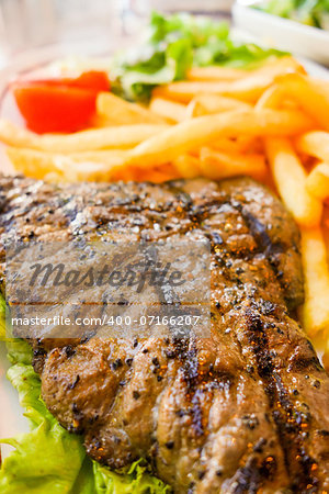 juicy steak beef meat with tomato and french fries