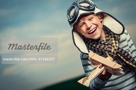 Laughing child with wooden plane