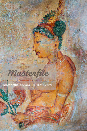 Ancient wall paintings of cloudy maiden with flower. One of the 5th century frescoes at the ancient rock fortress of Sigiriya, Sri Lanka.