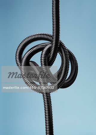 Tangled black flexible air hose.
