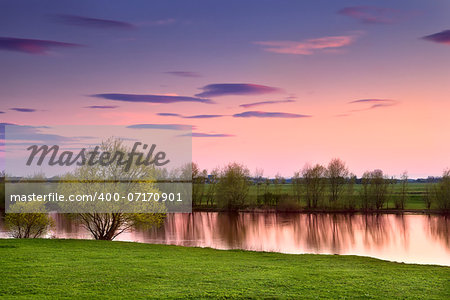 colorful sunset over calm river, Gelderland, Netherlands