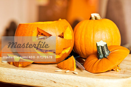 Carving up pumpkins into Jack O Lanterns for Halloween.