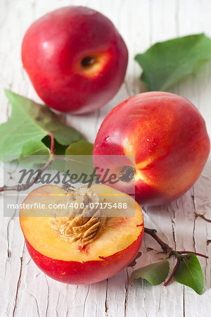 Sweet fresh nectarines on an old wooden board.