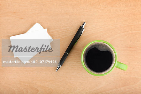 Blank business cards with pen and coffee cup on wooden office table
