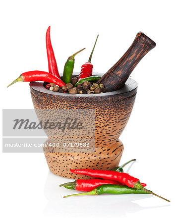 Mortar and pestle with red hot chili pepper and peppercorn. Isolated on white background