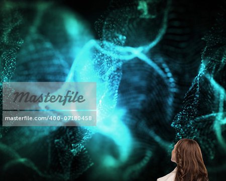 Composite image of brunette businesswoman looking up on black background with blue glowing pattern