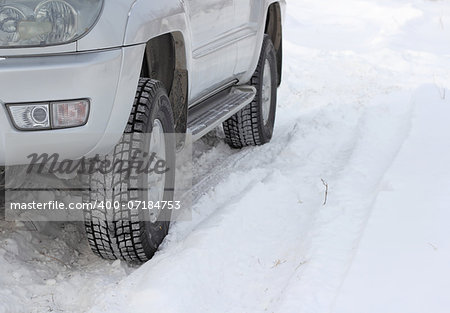 Snowy winter road ahead an unrecognizable car