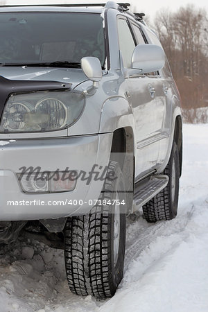 Snowy winter road ahead an unrecognizable car