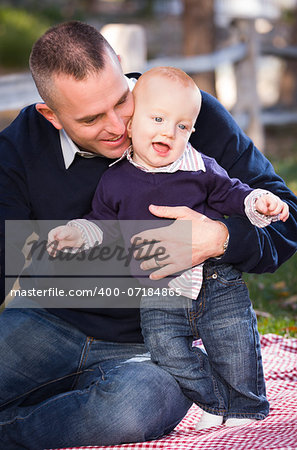 Adorable Infant Boy and Young Military Father Play Together in the Park.