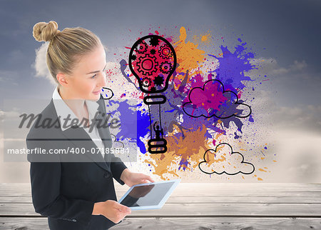 Composite image of blonde businesswoman holding tablet