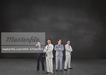 Composite image of attractive businessmen standing arms crossed