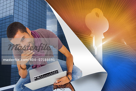 Composite image of thoughtful man sitting on floor using laptop and smiling at camera