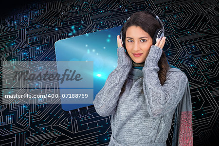 Composite image of beautiful model wearing winter clothes listening to music