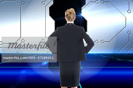 Composite image of blonde businesswoman standing with hands on hips