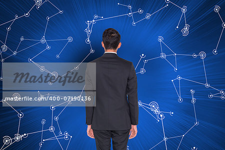 Composite image of rear view of businessman