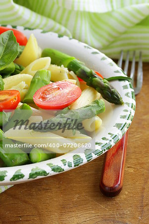 penne pasta with tomatoes and asparagus, fresh spring food