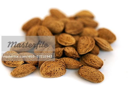 Macro view of almonds in shell isolated on white