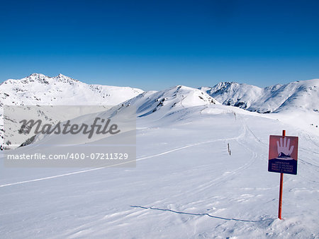 A sign in the Austrian alps wich says danger of avalanches