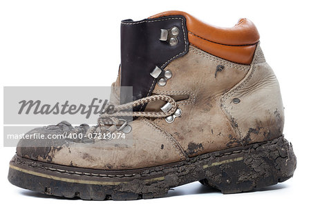 Old dirty hiking boot isolated on white background