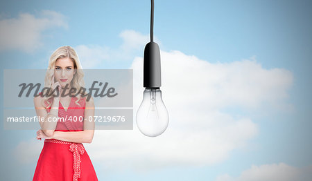 Composite image of thoughtful elegant blonde wearing red dress