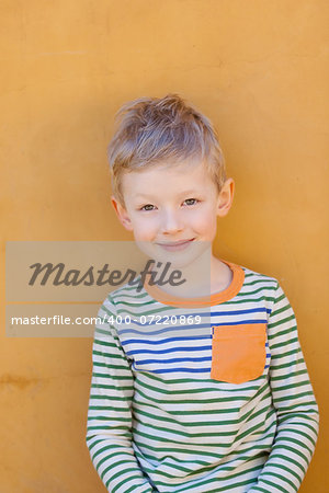 portrait of positive smiling boy outside