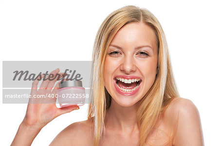 Portrait of smiling teenage girl showing creme