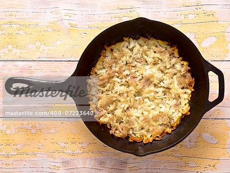 close up of a pan of fried rosti potatoes