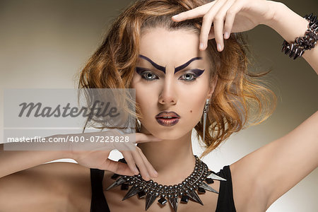 close-up portrait of pretty woman with crazy style, creative purple make-up and gothic accessories
