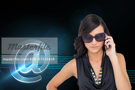 Composite image of serious elegant brunette wearing sunglasses on the phone