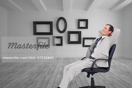 Composite image of side view of businessman leaning back in his chair
