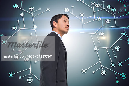 Composite image of serious asian businessman