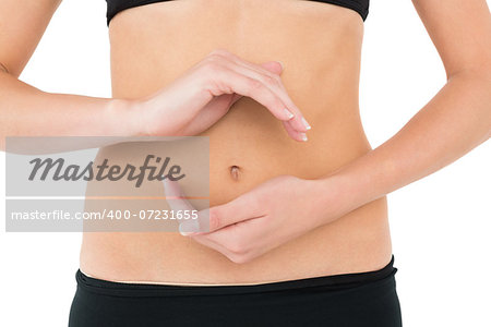 Close-up mid section of a fit woman with hand gestures over white background