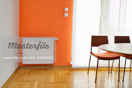 Heating Readiator on the Orange Wall