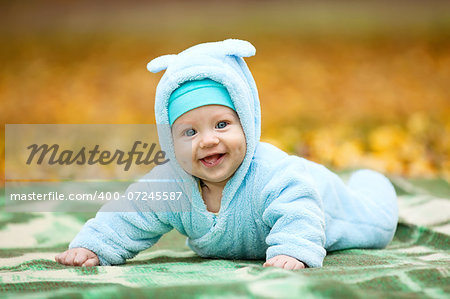 Happy baby boy in autumn park