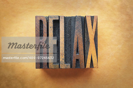 The word RELAX written in vintage letterpress type.