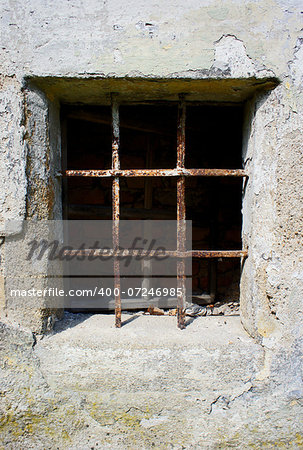 old grunge small window barred by rusty bar
