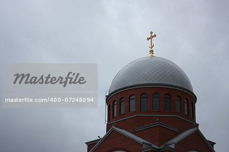 church dome with golden cross on it