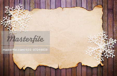 Old burnt empty paper  and decorative snowflakes