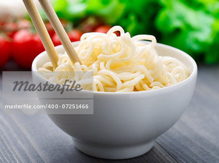 Noodles in a bowl on a wooden table