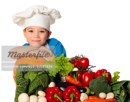 Six years old cook boy with different vegetables isolated on white