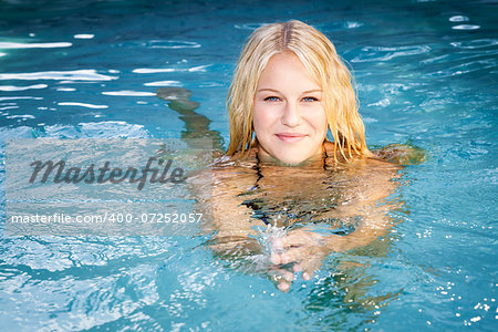 An image of a beautiful woman swimming in the pool