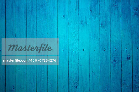 Part of wooden fence with tightly fastened new boards painted in blue color