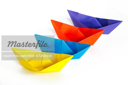 Four colored paper ship on a white background