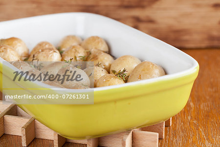 Roasted baby potatoes with thyme, olive oil and salt on baking sheet