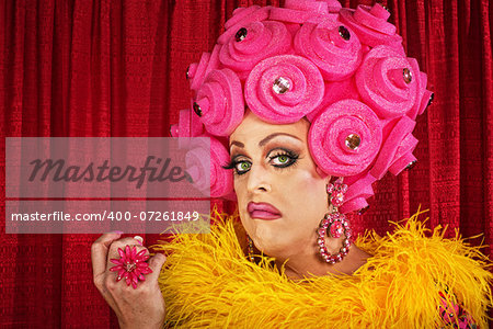 Conceited drag queen with foam pink flower wig