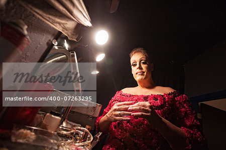 Man in backstage dressing up as a woman