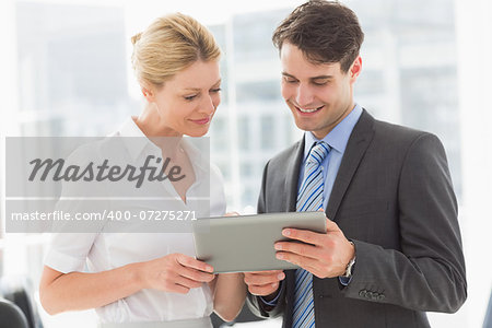 Business team looking at tablet pc together in the office